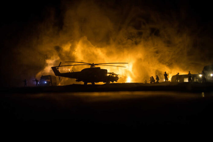 Silhouette,Of,Military,Helicopter,Ready,To,Fly,From,Conflict,Zone.