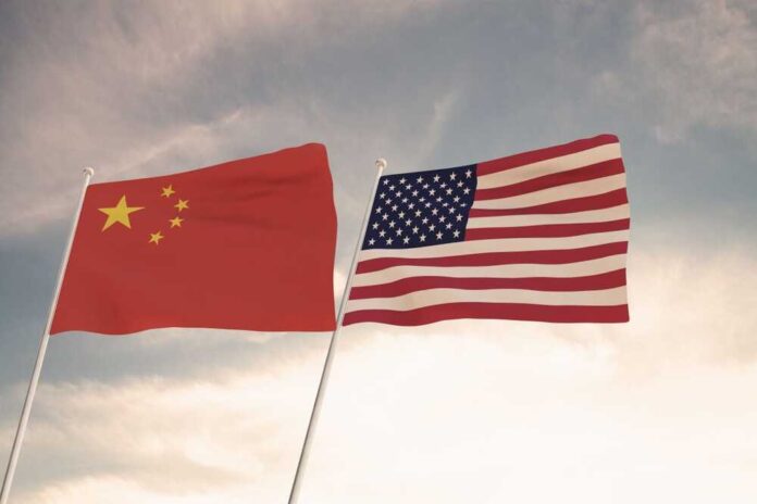 Flags,Of,China,And,Usa,Waving,With,Cloudy,Blue,Sky
