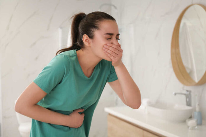 Young,Woman,Suffering,From,Nausea,In,Bathroom.,Food,Poisoning
